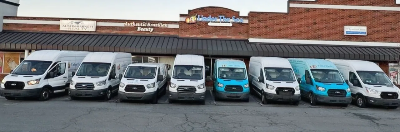 The Under The Sea fleet of eight aquarium service vans parked outside the Monroe, NC shop