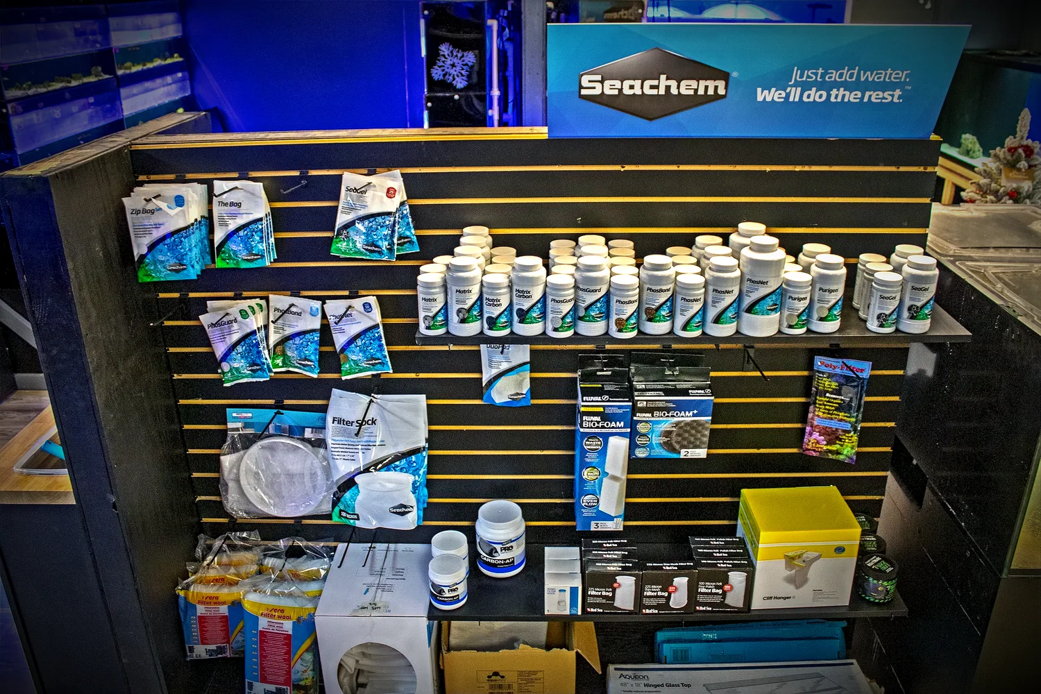 The Seachem water care wall inside the Under The Sea showroom, stocked with conditioners, filter media and test kits
